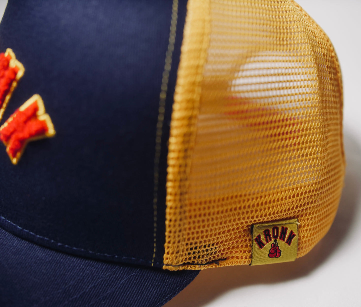 KRONK WAR Trucker Cap: Navy with Yellow Mesh and Red & Yellow Towelling Embroidery